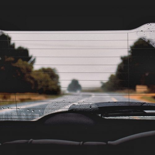 234043-view-from-the-backseat-of-a-car-through-a-wet-rear